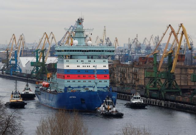 The nuclear-powered icebreaker Arktika is seen drawn by tug boats as it starts the sea trials, in Saint Petersburg
